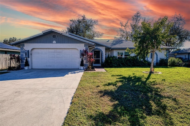 single story home with a yard and a garage