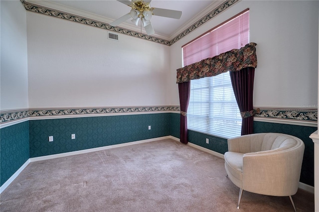 unfurnished room with carpet floors, ceiling fan, and ornamental molding