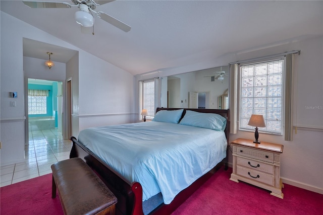 bedroom featuring tile patterned floors, multiple windows, ceiling fan, and lofted ceiling