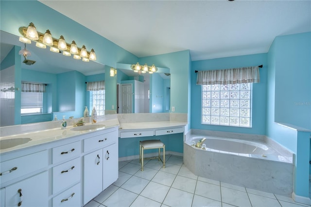 bathroom featuring vanity, tiled bath, and tile patterned floors