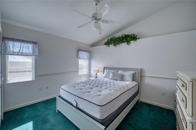 bedroom with multiple windows, ceiling fan, dark carpet, and vaulted ceiling