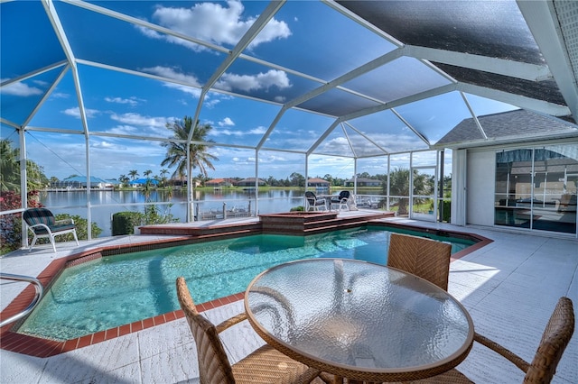 view of swimming pool featuring a patio, a water view, a dock, and a lanai