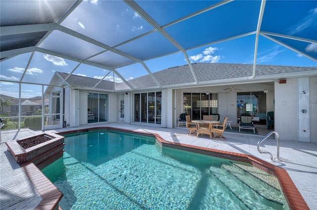 view of swimming pool featuring a lanai, ceiling fan, and a patio area