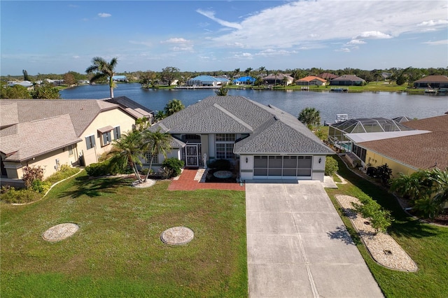 view of front of property featuring a front lawn, a water view, and a garage