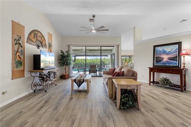 living room featuring ceiling fan, light hardwood / wood-style floors, and vaulted ceiling