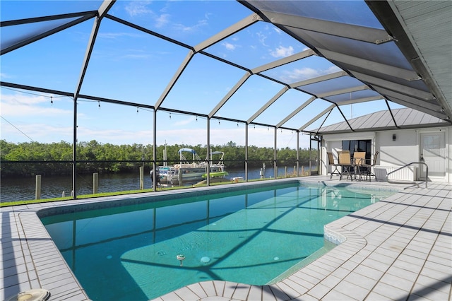 view of pool with a patio, a water view, and glass enclosure