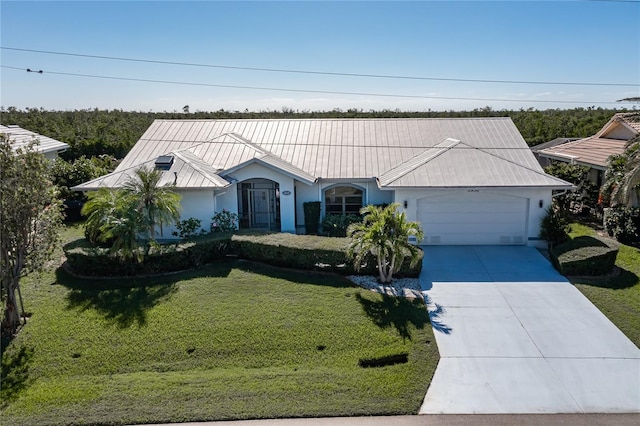 view of front of house with a front yard and a garage