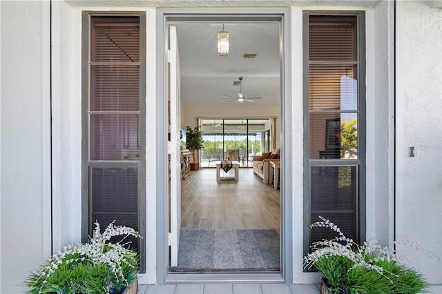 doorway to property with ceiling fan