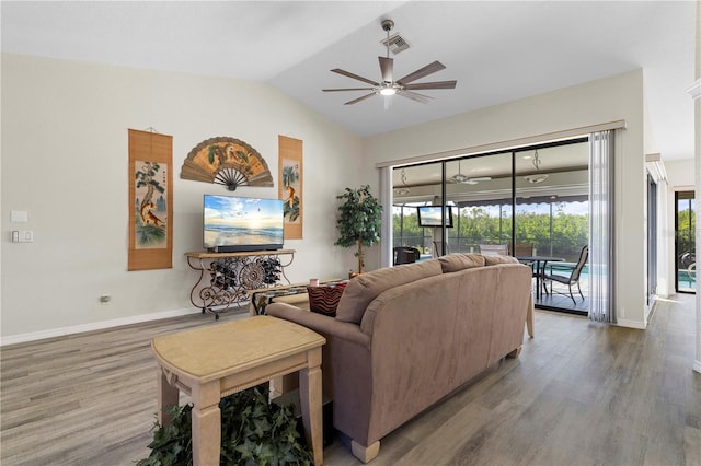 living room with ceiling fan, wood-type flooring, and lofted ceiling