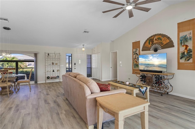 living room with light wood-type flooring, vaulted ceiling, and ceiling fan