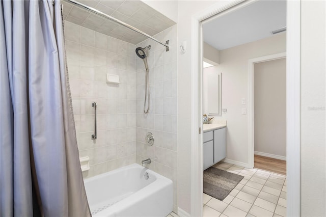 bathroom featuring tile patterned flooring, shower / bath combo, and vanity