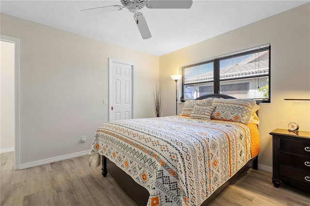 bedroom with ceiling fan and hardwood / wood-style floors