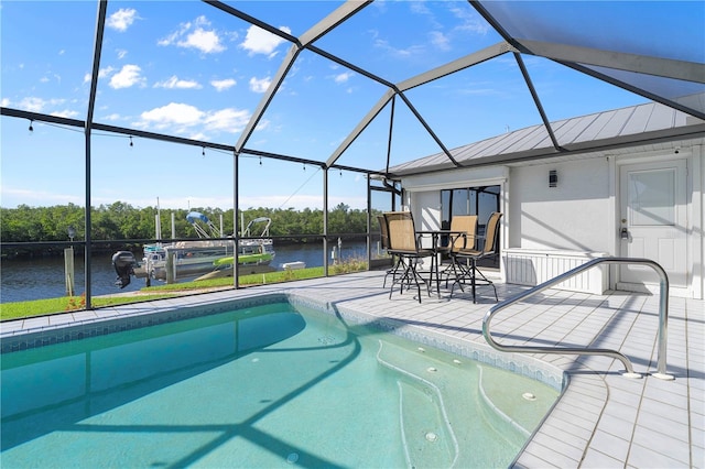 view of swimming pool featuring a lanai, a patio area, and a water view