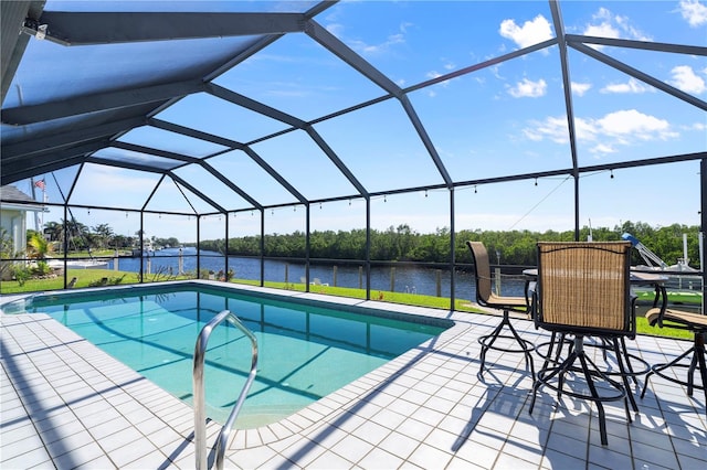 view of pool with a lanai, a water view, and a patio