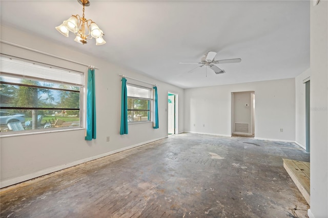 empty room featuring ceiling fan with notable chandelier