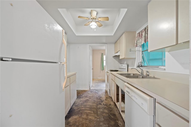 kitchen with ceiling fan, sink, a tray ceiling, and white appliances