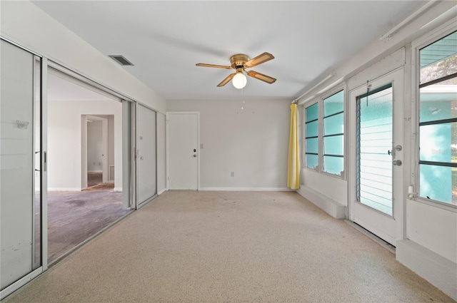 unfurnished room with ceiling fan and light colored carpet