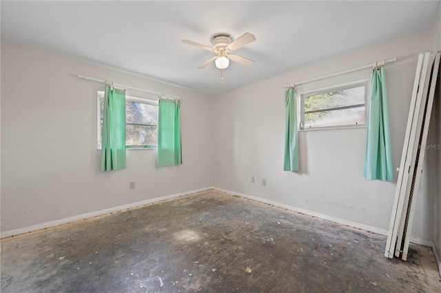 spare room featuring ceiling fan and concrete flooring