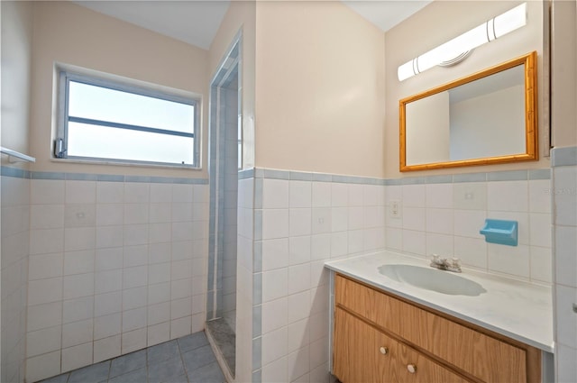 bathroom featuring vanity, tile walls, and tile patterned floors