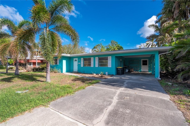 ranch-style house with a front lawn and a carport