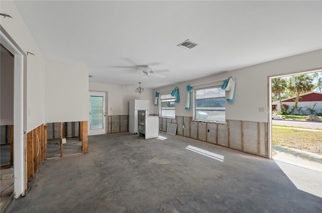 unfurnished living room featuring concrete flooring and ceiling fan