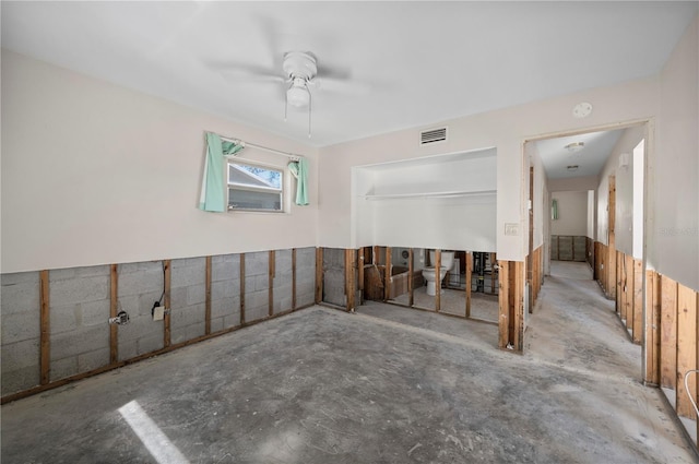 spare room with concrete flooring and ceiling fan