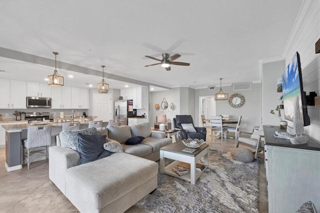 tiled living room featuring ceiling fan, sink, and ornamental molding