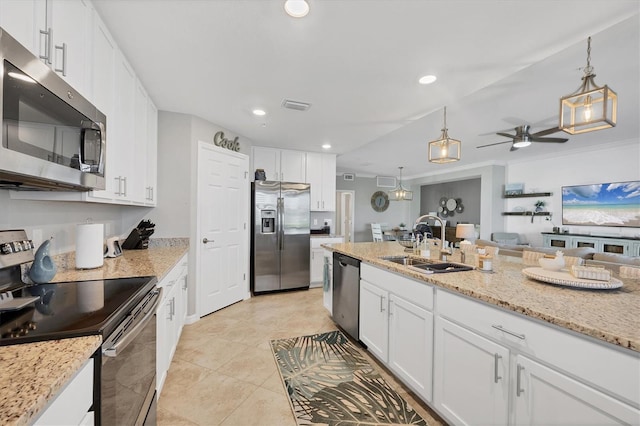 kitchen with white cabinets, decorative light fixtures, sink, and appliances with stainless steel finishes