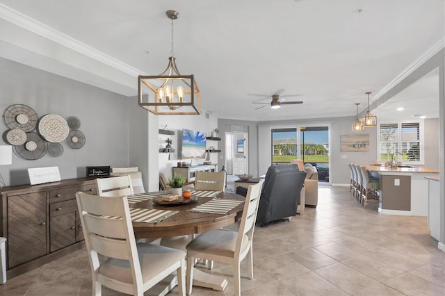 tiled dining room featuring ceiling fan with notable chandelier and ornamental molding