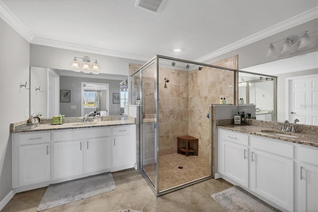 bathroom with tile patterned flooring, ornamental molding, vanity, and a shower with shower door