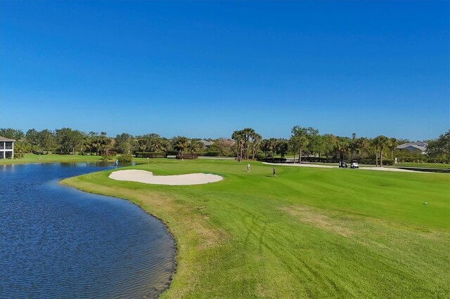 surrounding community featuring a water view and a yard