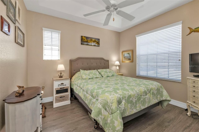 bedroom with ceiling fan and dark hardwood / wood-style flooring