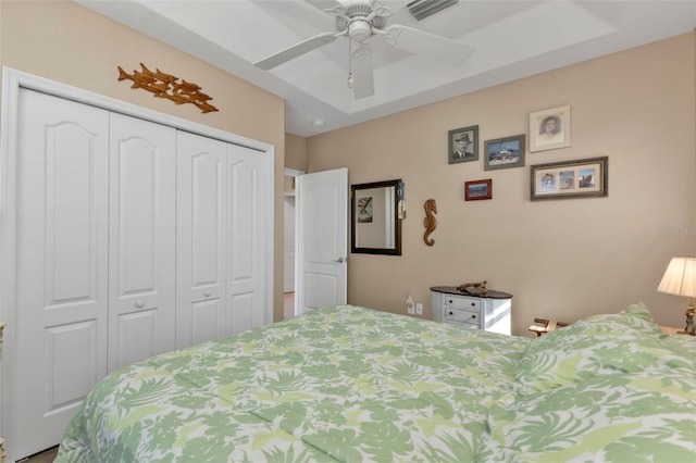 bedroom with ceiling fan and a closet