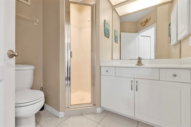 bathroom with tile patterned floors, vanity, an enclosed shower, and toilet