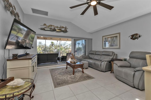 living room with ceiling fan, light tile patterned floors, and vaulted ceiling