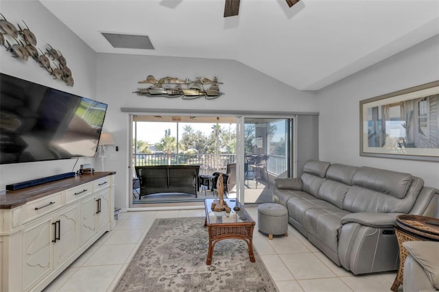 tiled living room featuring ceiling fan and vaulted ceiling