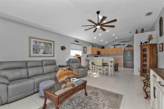 living room featuring light tile patterned floors, vaulted ceiling, and ceiling fan