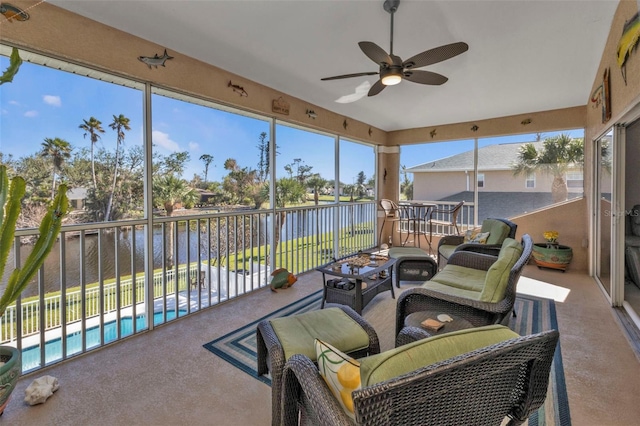 sunroom with a water view and ceiling fan