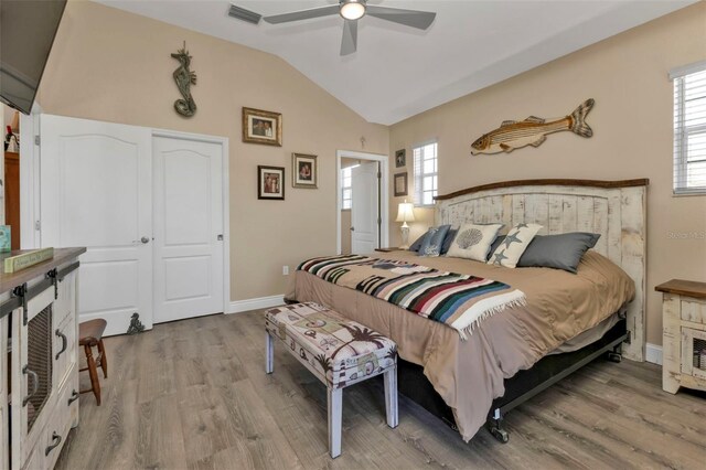 bedroom featuring wood-type flooring, ceiling fan, and lofted ceiling