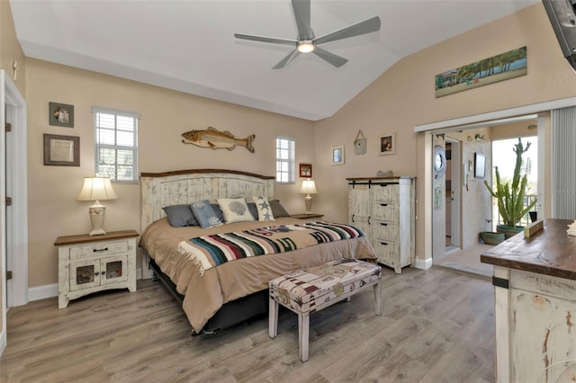 bedroom with access to exterior, hardwood / wood-style flooring, ceiling fan, and lofted ceiling