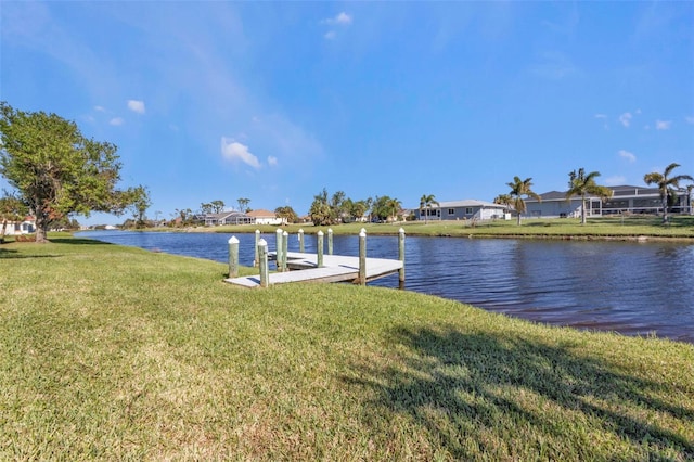 view of dock with a water view and a yard