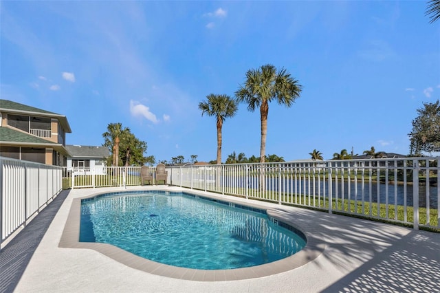 view of pool featuring a patio and a water view