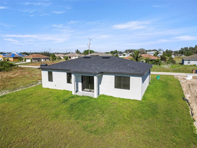 rear view of property with a yard