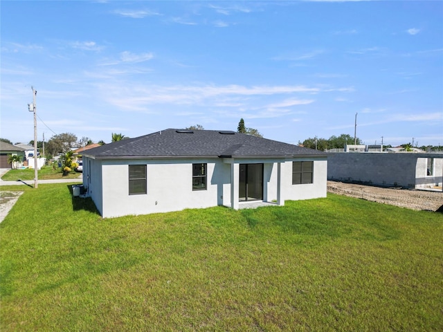 rear view of property with a lawn