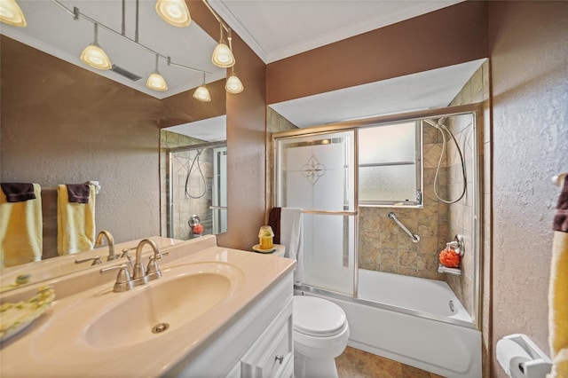 full bathroom with vanity, toilet, ornamental molding, and bath / shower combo with glass door