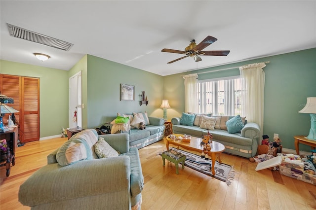 living room with ceiling fan and light hardwood / wood-style floors