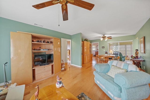 living room featuring light hardwood / wood-style floors and ceiling fan