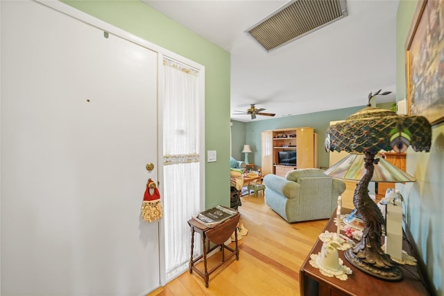 interior space with wood-type flooring and ceiling fan