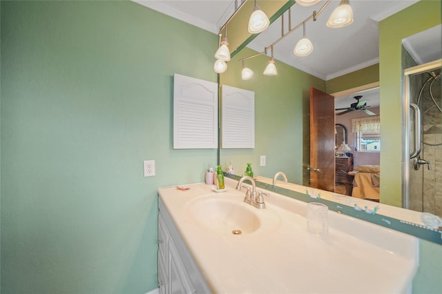 bathroom with walk in shower, vanity, ceiling fan, and ornamental molding