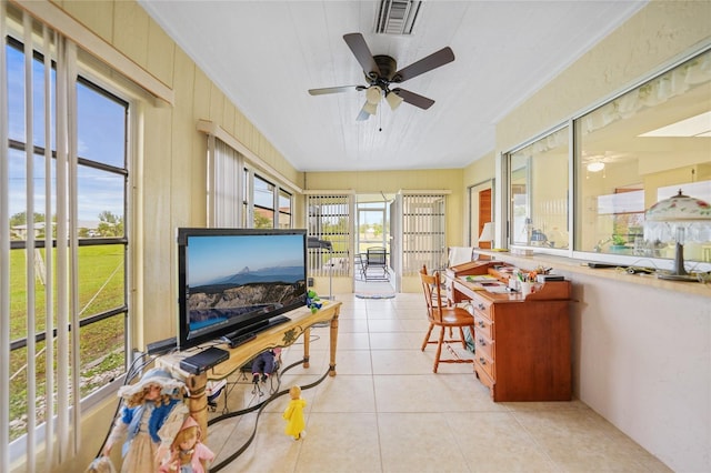 sunroom featuring ceiling fan